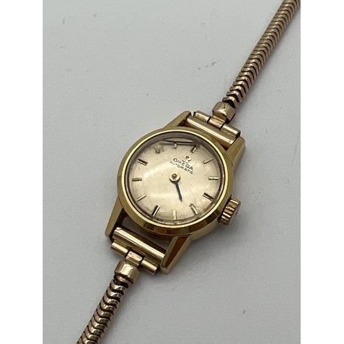 1198 - A ladies vintage 551002 automatic wristwatch by Omega. Gold tone case with rolled gold strap. One ha... 