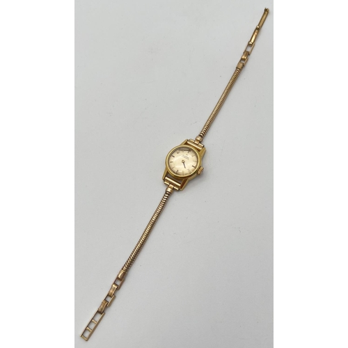 1198 - A ladies vintage 551002 automatic wristwatch by Omega. Gold tone case with rolled gold strap. One ha... 