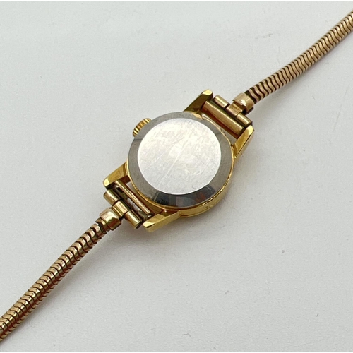 1198 - A ladies vintage 551002 automatic wristwatch by Omega. Gold tone case with rolled gold strap. One ha... 