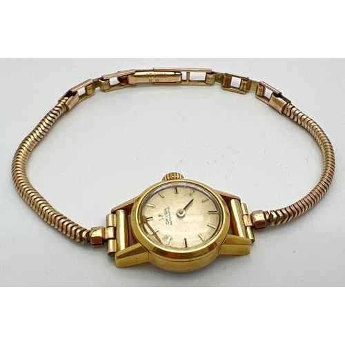 1198 - A ladies vintage 551002 automatic wristwatch by Omega. Gold tone case with rolled gold strap. One ha... 