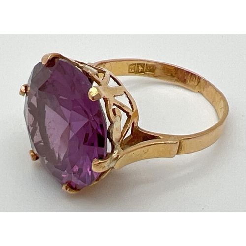 157 - An 18k Egyptian gold dress ring set with a large round cut purple amethyst. Pierced heart detail to ... 