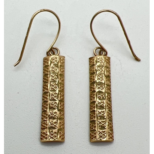 1002 - A pair of 9ct gold vintage drop style earrings with diamond shaped decoration to fronts. Each earrin... 