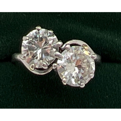 1006 - A vintage platinum and 2.8ct diamond twist design ring. 2 round brilliant cut diamonds, vendor advis... 