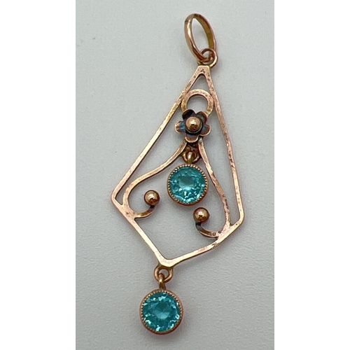 1007 - An Art Nouveau 9ct rose gold floral detail drop pendant set with 2 round cut bezel set blue topaz st... 