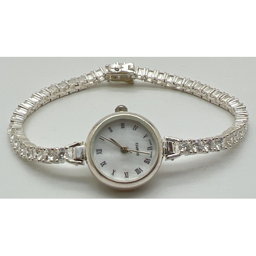 1190 - A modern silver cased ladies quartz wristwatch with mother of pearl face and clear stone set bracele... 