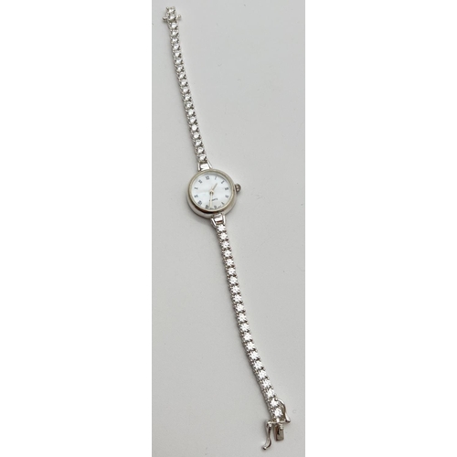 1190 - A modern silver cased ladies quartz wristwatch with mother of pearl face and clear stone set bracele... 