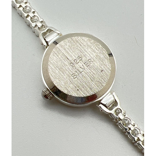 1190 - A modern silver cased ladies quartz wristwatch with mother of pearl face and clear stone set bracele... 