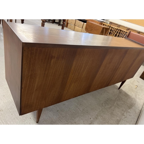 1387 - A mid century Afrormosia wood triple sideboard by Richard Hornby for Heals. Raised on tapered legs, ... 