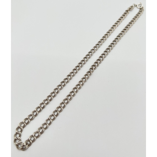 1031 - An 18 inch silver double belcher chain with spring ring clasp. Silver marks to clasp and fixings. To... 