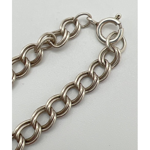 1031 - An 18 inch silver double belcher chain with spring ring clasp. Silver marks to clasp and fixings. To... 