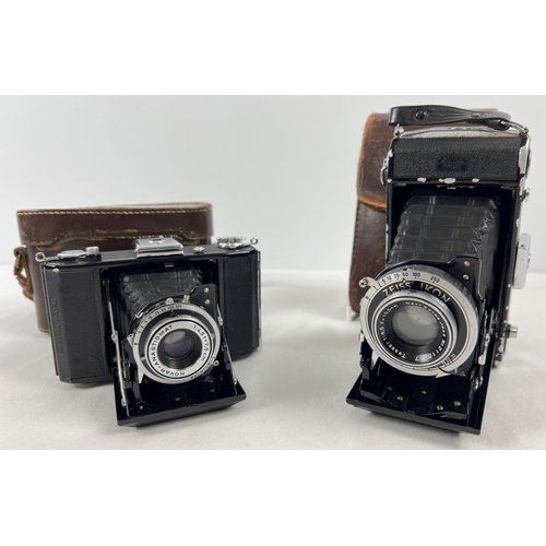 1303 - 2 vintage Zeis Ikon cameras in original brown leather cases & concertina fold-out lenses. A Zeiss Ik... 