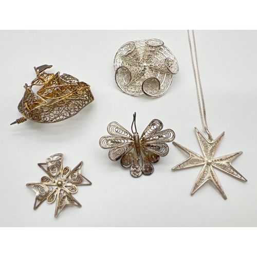 1035 - A collection of silver and white metal filigree jewellery brooches and pendants. To include butterfl... 