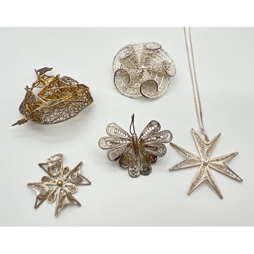 1035 - A collection of silver and white metal filigree jewellery brooches and pendants. To include butterfl... 