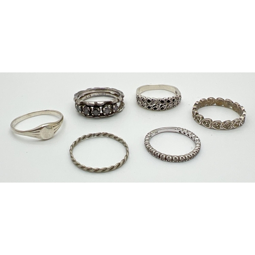 1038 - 6 silver and white metal band style and signet rings. To include heart shaped set with marcasite's a... 