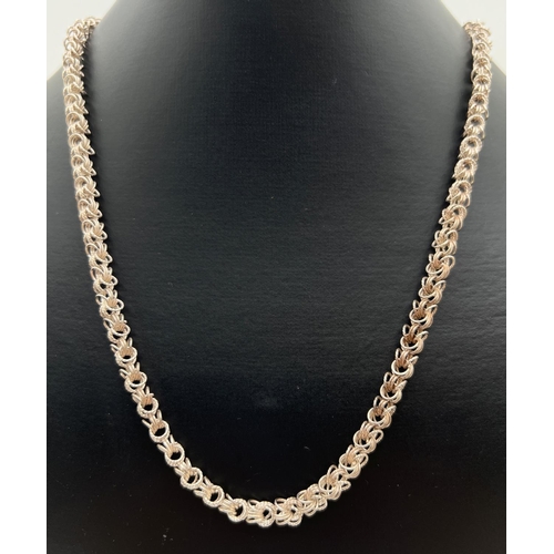 1040 - A 20 inch vintage silver byzantine style chain necklace with spring clasp. Silver marks to fixings. ... 