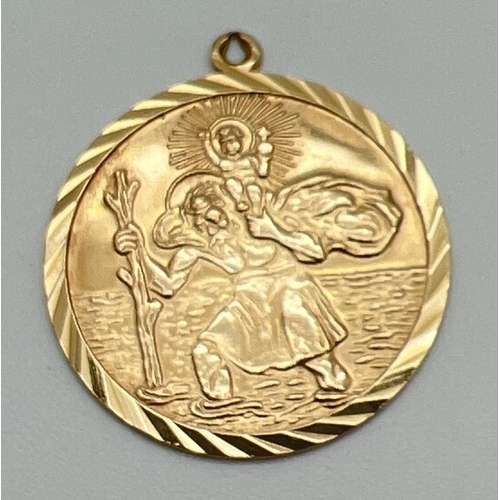 1041 - A 9ct gold double-sided circular St. Christopher pendant with fixed hanging bale. Reverse depicts ai... 