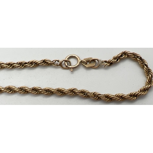 1053 - A 9ct gold 16 inch rope chain with spring ring clasp. Gold marks to clasp and fixings. Total weight ... 