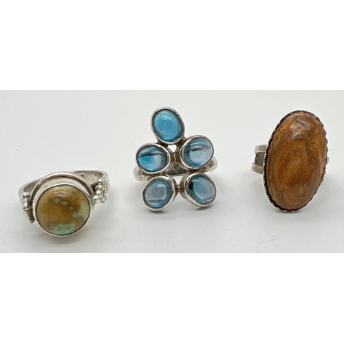 1054 - 3 modern design stone set silver dress rings all with silver marks. To include an 800 silver adjusta... 