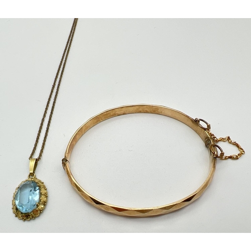 1062 - 2 items of rolled gold jewellery. A 14ct rolled gold oval pendant set with a blue stone in a floral ... 