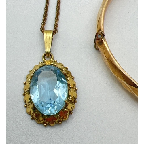 1062 - 2 items of rolled gold jewellery. A 14ct rolled gold oval pendant set with a blue stone in a floral ... 