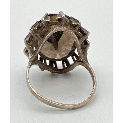 1063 - A vintage silver cocktail ring set with a large oval cut smoked quartz stone. Hallmarked to inside o... 