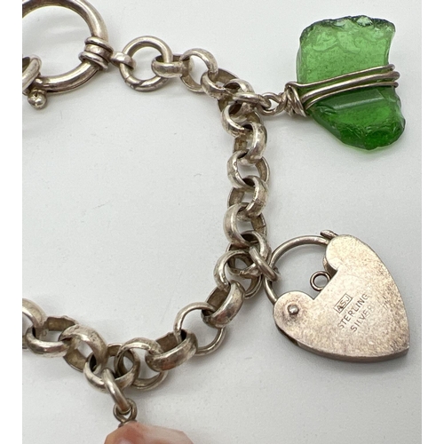 1066 - A belcher chain style charm bracelet with large spring clasp and 5 charms. Charms include a padlock,... 