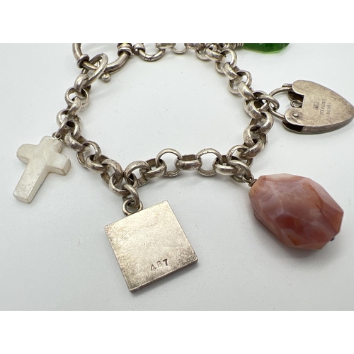 1066 - A belcher chain style charm bracelet with large spring clasp and 5 charms. Charms include a padlock,... 