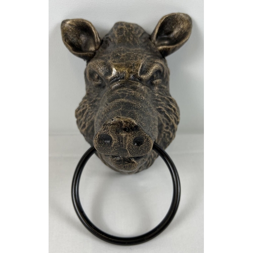 1222 - A bronzed effect painted cast iron wall hanging Boar head with metal ring. Approx 18cm tall.