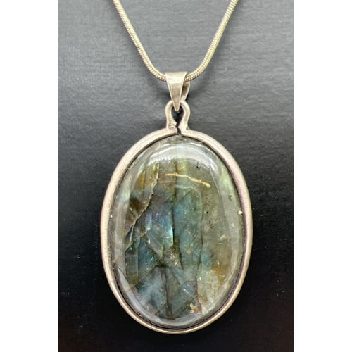 1078 - A large oval labradorite & white metal pendant on a 16