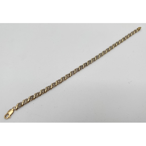 1080 - A 7.5 inch 9ct gold and diamond decorative bracelet. 30 small wave design panels, 15 set with a smal... 