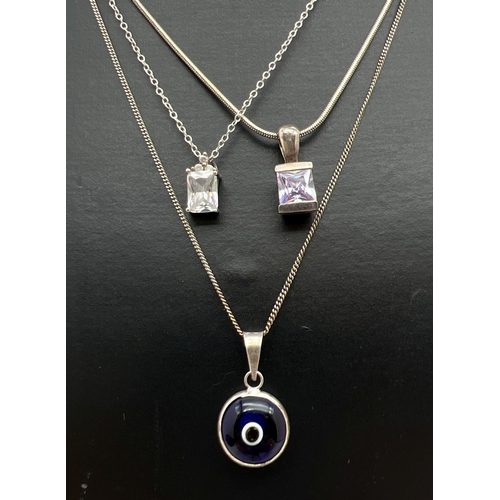 1090 - 3 silver necklaces. A square cut clear stone with 3 small round cut clear stones to top pendant on a... 