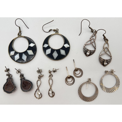 1099 - 6 pairs of drop style silver and white metal earrings. To include geode, treble clef set with a sing... 