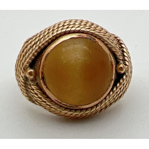 1105 - A vintage 18ct gold wrap over style pale yellow cats eye stone set dress ring. Rope design wrap over... 