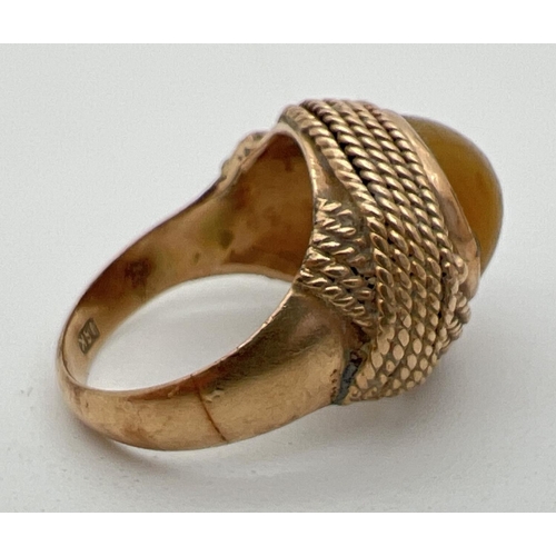 1105 - A vintage 18ct gold wrap over style pale yellow cats eye stone set dress ring. Rope design wrap over... 