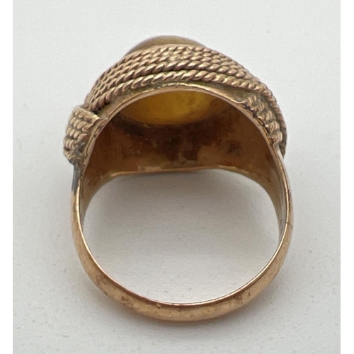 1105 - A vintage 18ct gold wrap over style pale yellow cats eye stone set dress ring. Rope design wrap over... 