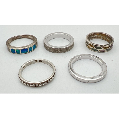 1107 - 5 silver band style rings in varying sizes and patterns. To include paua shell set and crushed diamo... 