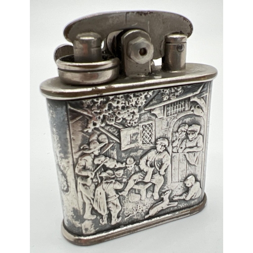 1339 - A 1930's Colibri one hand kickstarter petrol lighter with 830 continental silver repousse jacket. De... 