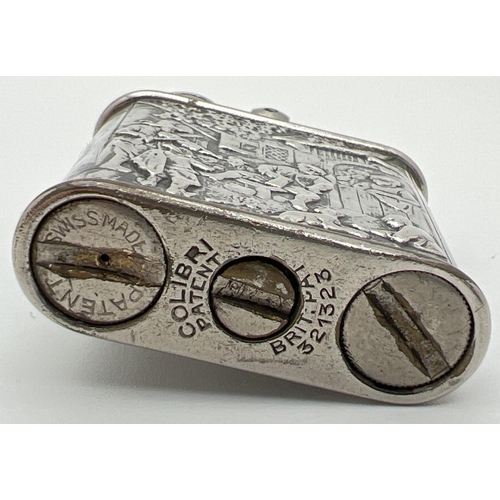 1339 - A 1930's Colibri one hand kickstarter petrol lighter with 830 continental silver repousse jacket. De... 