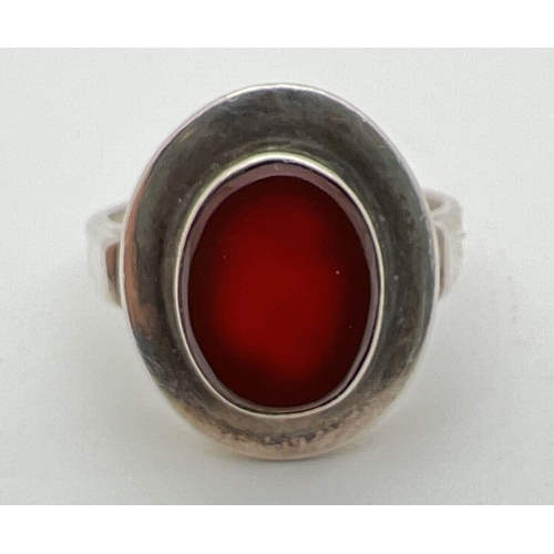 1109 - A silver contemporary style oval shaped ring set with carnelian. 925 stamped to inside of band. Size... 