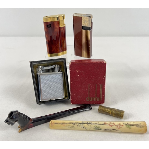 1341 - A small collection of assorted vintage smoking related items to include lighters and cigarette holde... 