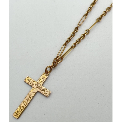 1112 - A vintage 9ct gold cross pendant with floral engraved detail to front. On a 16 inch Figaro style lin... 