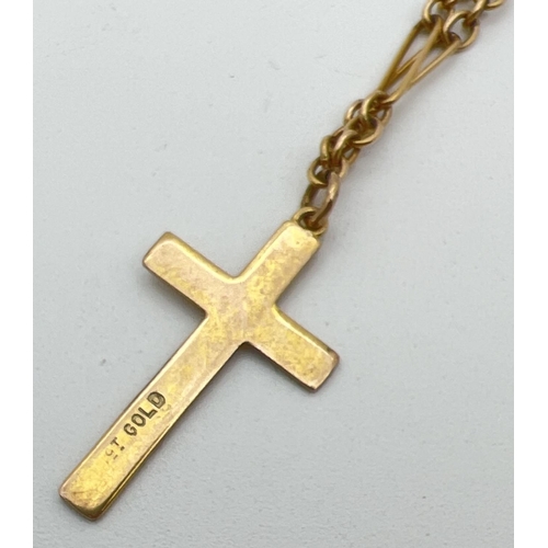 1112 - A vintage 9ct gold cross pendant with floral engraved detail to front. On a 16 inch Figaro style lin... 