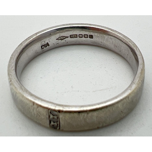 1113 - A 9ct white gold wedding ring set with 3 small round cut diamonds. Full hallmarks to inside of band.... 