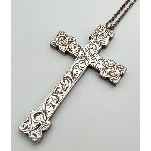 1117 - A large vintage heavy silver cross shaped pendant with floral engraved decoration to front. On a 22