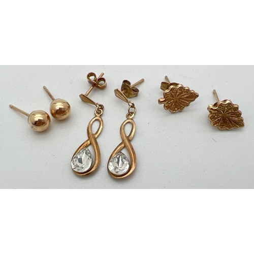 1119 - 3 pairs of gold earrings. A pair of infinity style drops set with a clear stone to each, a pair of l... 