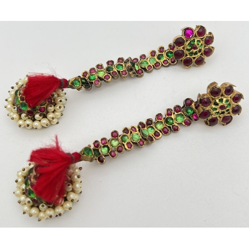 1126 - A pair of Indian ceremonial adjustable drop earrings set with green and red glass stones and faux pe... 