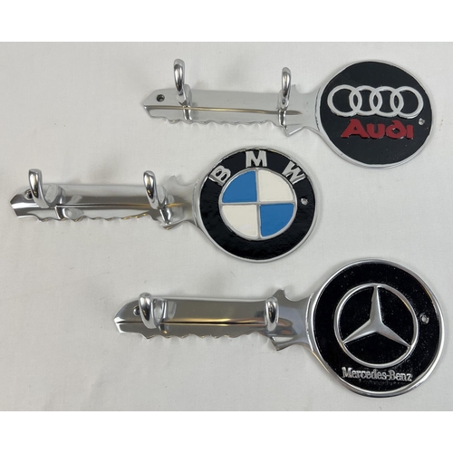 1325 - 3 aluminium wall hanging key hooks with painted car logo detail. Each approx. 30cm long.