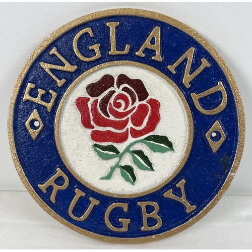 1237 - An England Rugby painted cast iron circular wall plaque, with fixing holes. Approx. 23cm diameter.