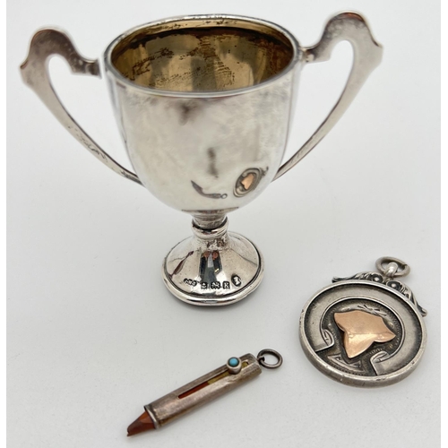 1206 - 3 silver items. A small sliding pencil with small turquoise glass cabochon, a small trophy cup witho... 