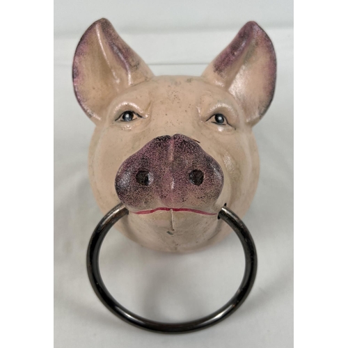 1243 - A painted cast metal wall mountable pigs head with a ring. Approx. 20.5cm tall.